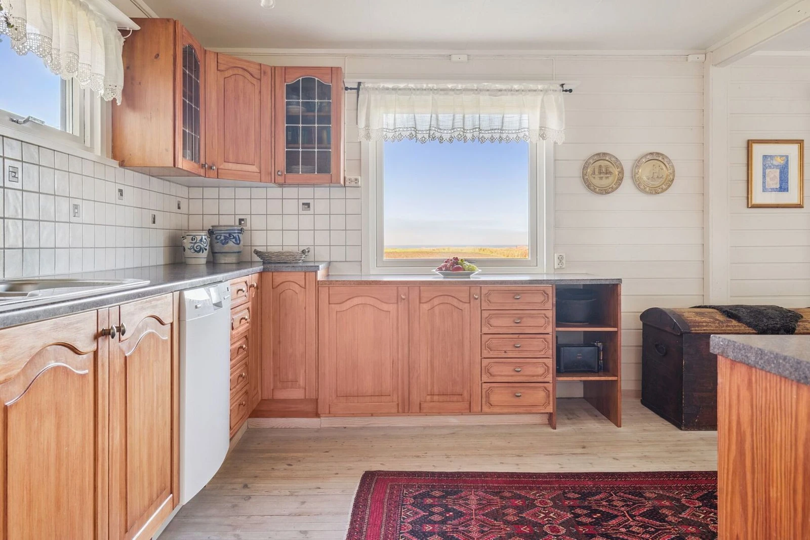 Kjøkkenet er romslig og har innredning med profilerte fronter og benkeplate av laminat Galleribilde