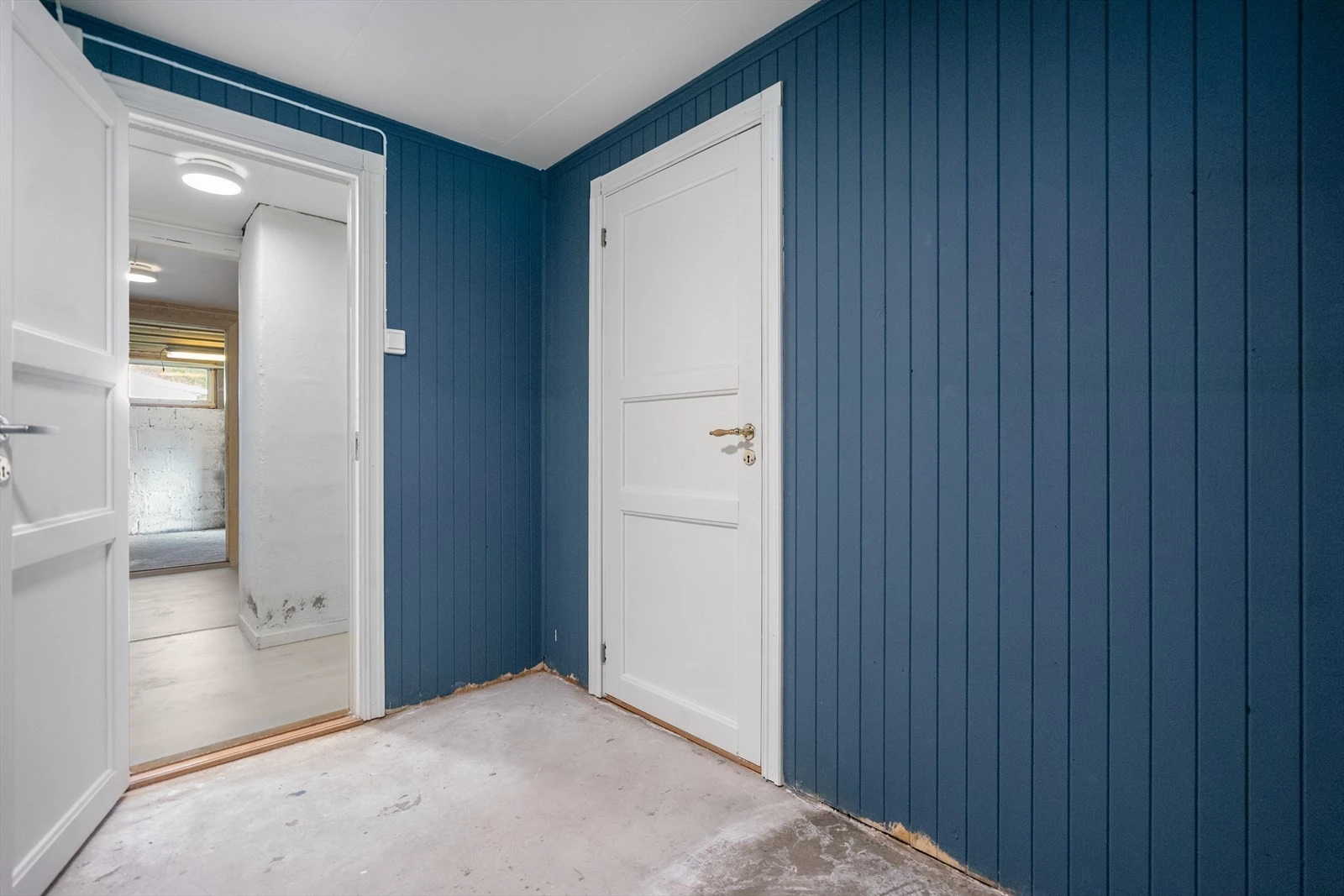 Kjellergang med adkomst til de ulike rommene i kjelleren Galleribilde