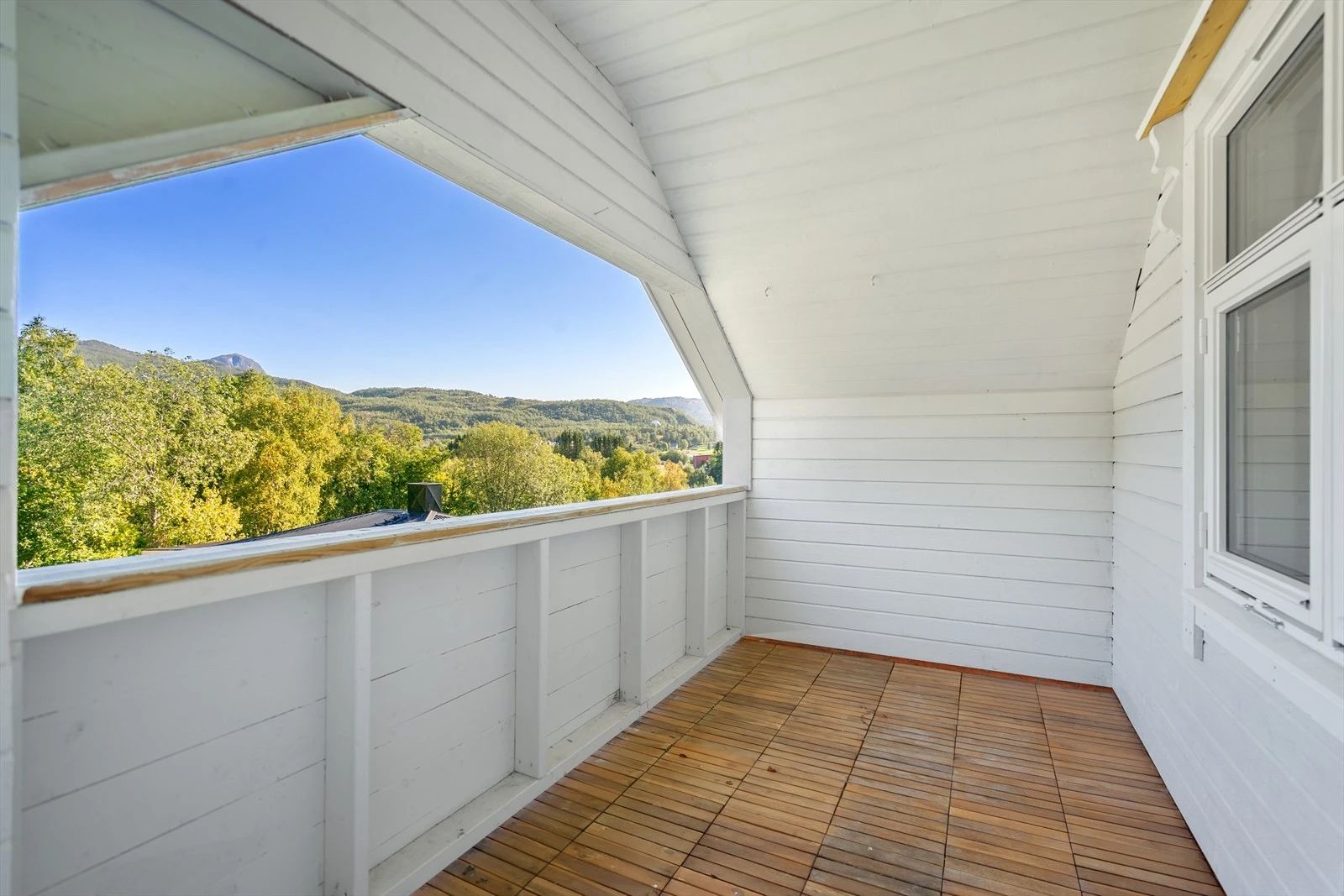 Trivelig uteplass under tak, med utsikt over nærområdet og naturen rundt - her er det mulig å skape en koselig oase ute Galleribilde