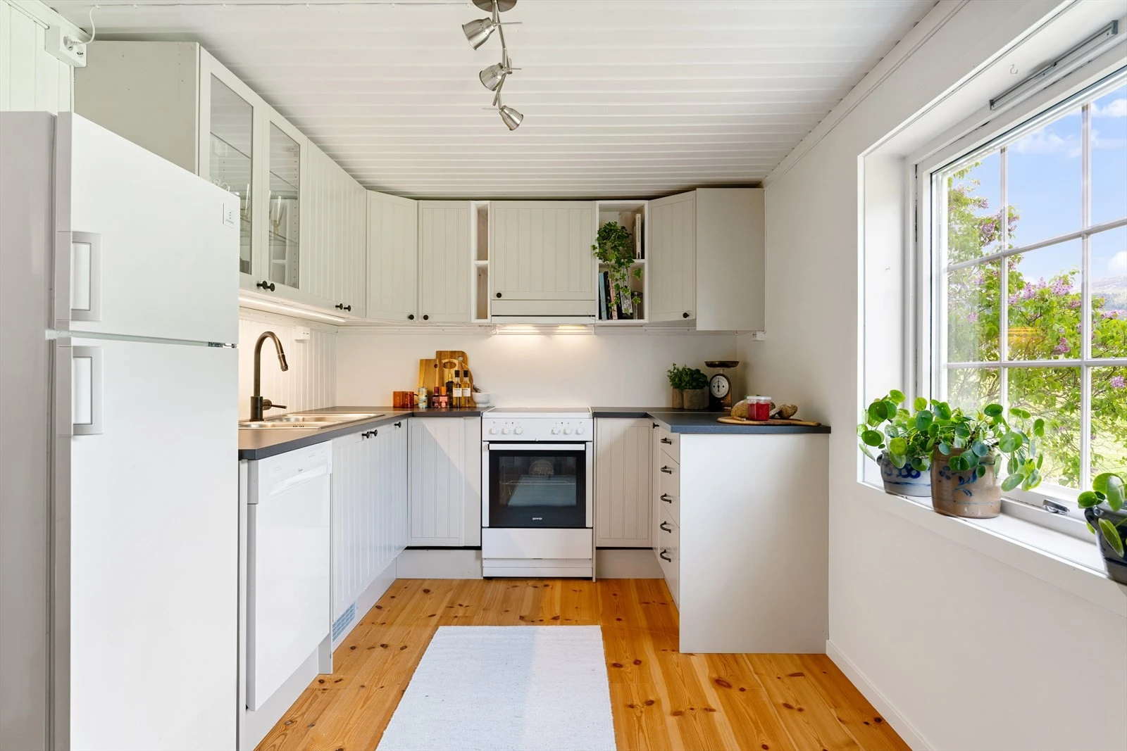 Romslig kjøkken på ca. 14 m². Kjøkkenet består av folierte skrog med profilerte fronter og laminert benkeplate. Galleribilde