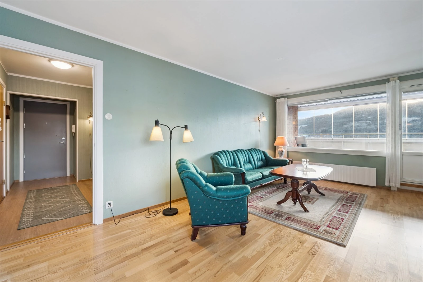 Lys og romslig stue med utgang til innglasset balkong