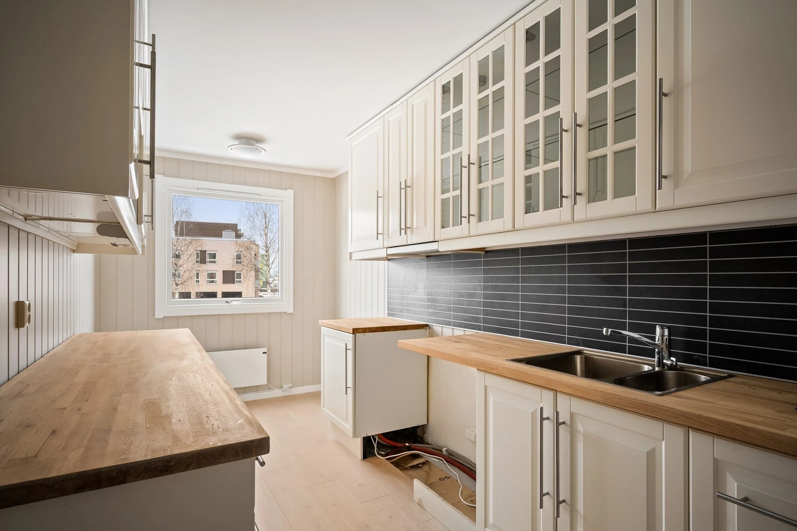 Praktisk kjøkken med frittstående hvitevarer og godt arbeidsområde.