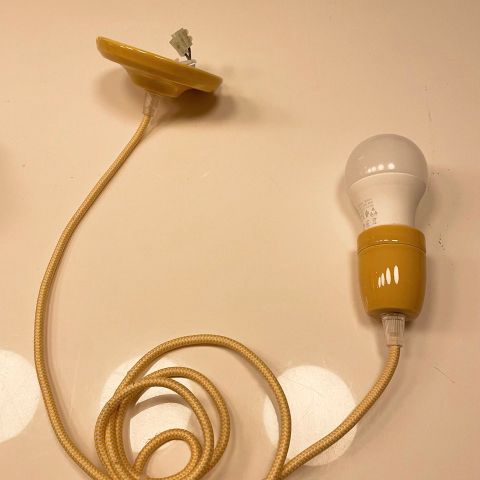 Yellow pendant lamp with light bulb