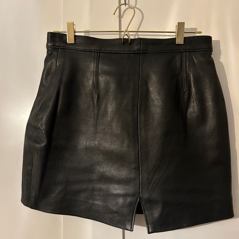 Vintage black leather mini skirt. Size medium/large.