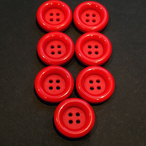 7 stykk runde røde knapper. Ø 23mm.