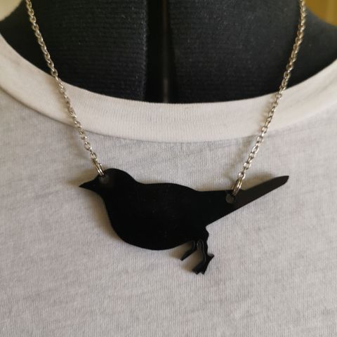 Halskjede med sort fugl