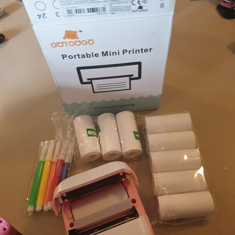 Relativt ny mini printer med ruller av papir og klistrelapper.