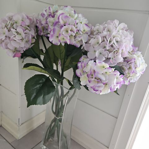 Høy vase med falske blomster