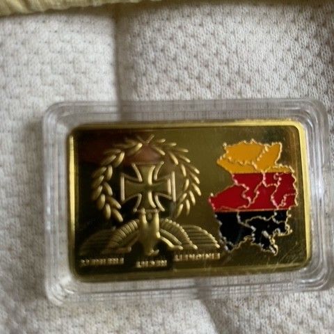 1 oz gold plated alien produced or 1oz gold bar. 3000-6500kroner.