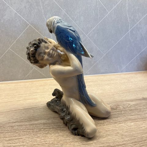 Royal Copenhagen, Danish porcelain model faun with parrot. Nummer 752.