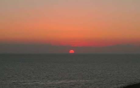 Solnedgang i havet fra terrassen Galleribilde