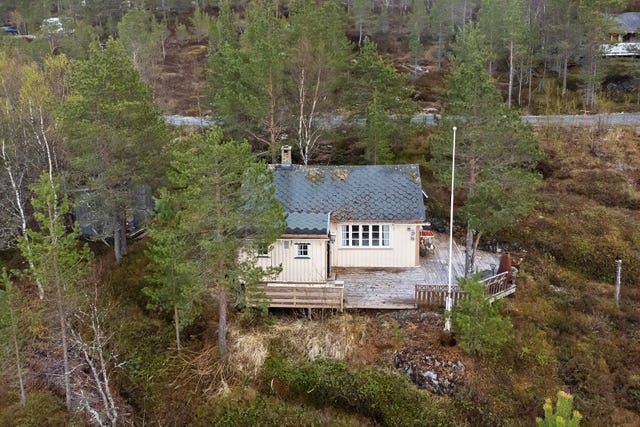På tomten er det oppført en hytte og et uthus.