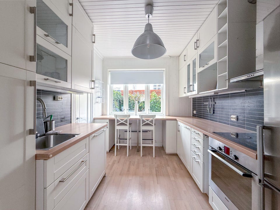 Worktop space on both sides and a dining area by the window.