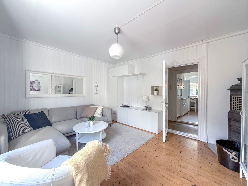 Bright, pleasant living room with room for a sofa set.