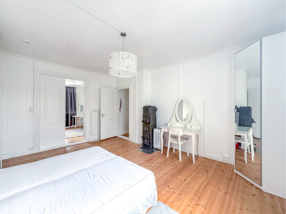 The bedroom has good floor space and room for a small desk or dressing table.