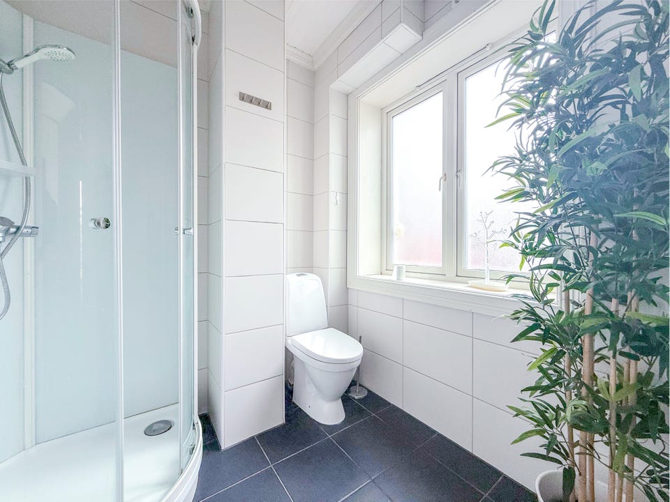 The bathroom has a window that lets in daylight.