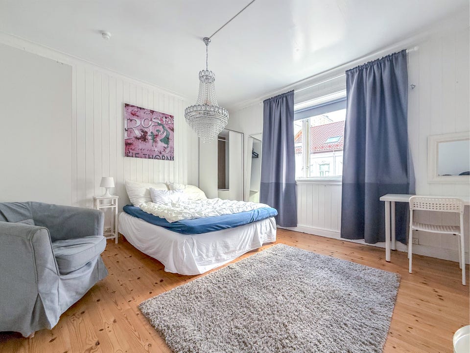 Spacious bedroom with room for both a bed and a seating area.