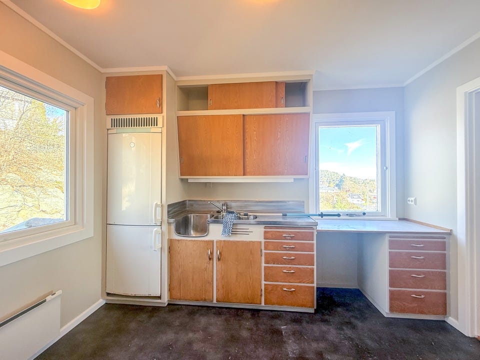 Kitchen with freestanding fridge.