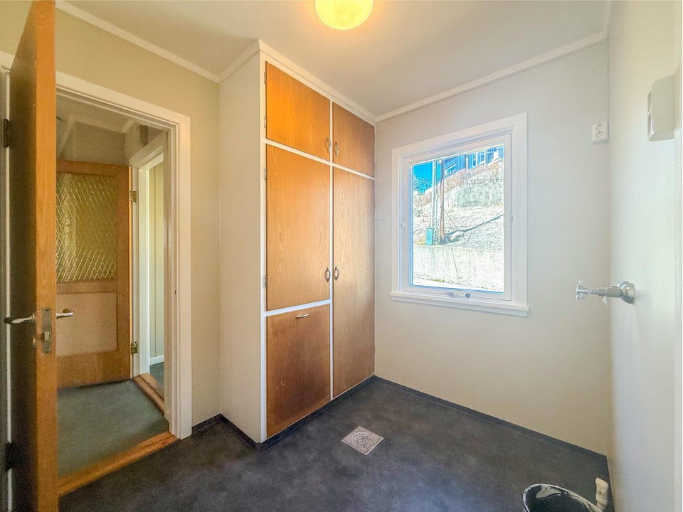 Utility room on the main floor, with access to the kitchen and landing.