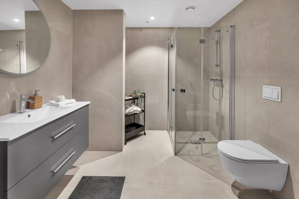 Bathroom 2 with modern vanity unit and connections for washing machine and tumble dryer.