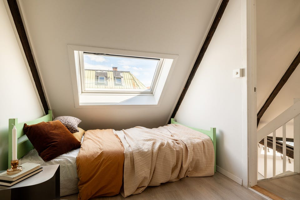 Soverommet har enstavs laminat på gulvet, lysmalte overflater og et takvindu som gir fint lysinnslipp.