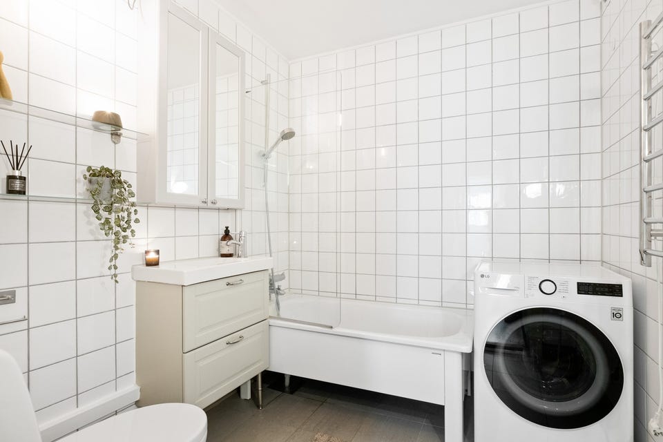 Romslig bad fra byggeår med badekar og opplegg for vaskemaskin og tørketrommel