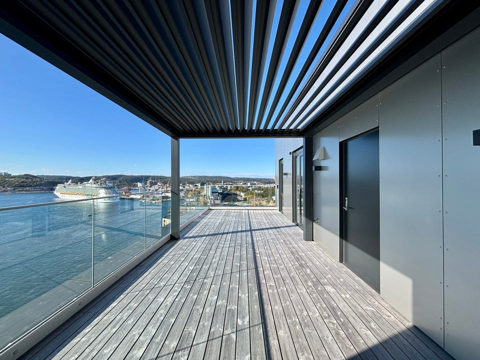 From the kitchen there is access to a lovely terrace with electric pergola.