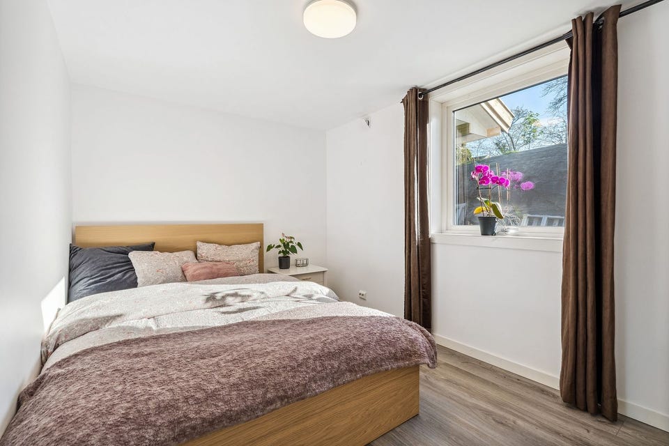 Bright bedroom with room for a double bed and wardrobe.