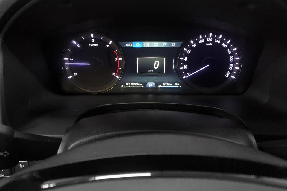 Digitalt instrumentpanel med tydelig midtdisplay og blå aksenter