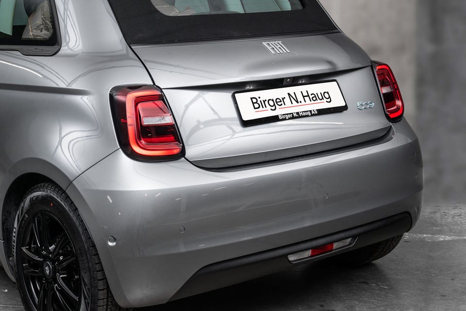 Runde LED-baklykter, svart cabriolet-tak, svarte felger og integrert spoiler