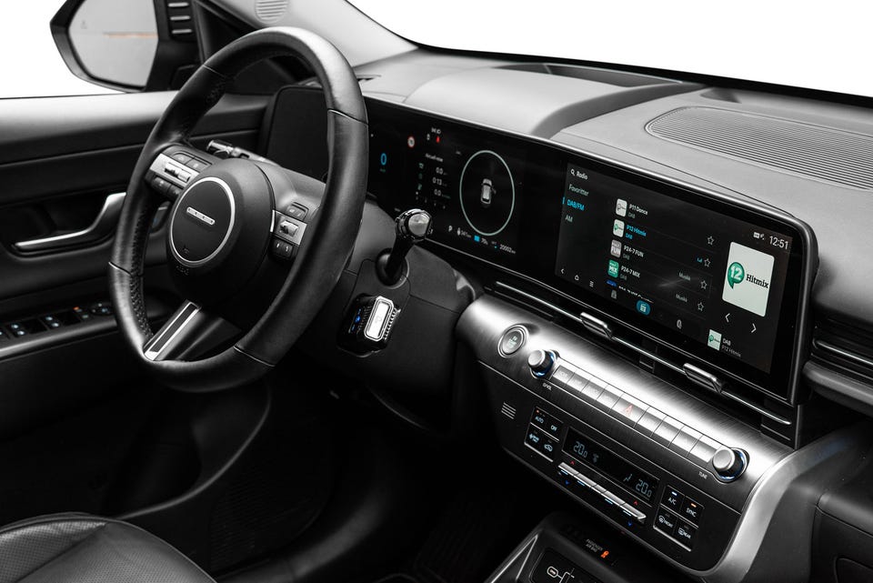 Dobbelt widescreen-display, digitalt instrumentpanel, skinnratt og metalldetaljer på midtkonsoll