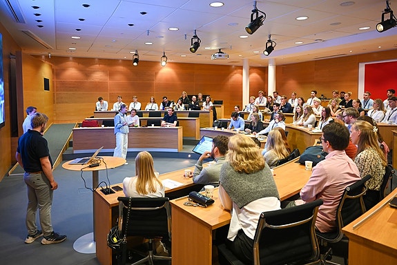 Summer interns presenting their case assignment for the jury