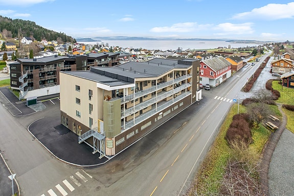 Svalganger med formiddagssol på inngangssiden og private terrasser mot fellesarealet med ettermiddag og kveldssol utover fine midtsommerkvelder.