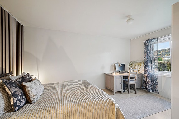 Romslig soverom med god plass til seng, garderobe og skrivebord.