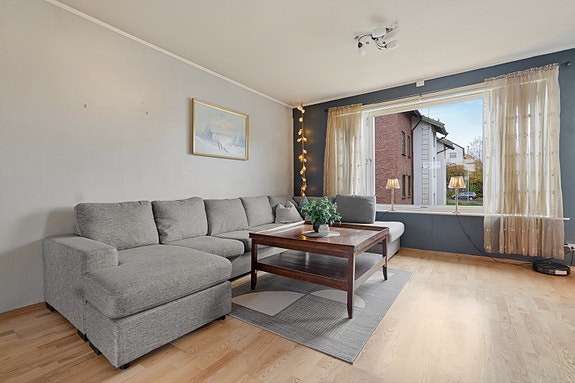 Hyggelig sofakrok med lysinnslipp fra vinduene  - et perfekt samlingspunkt for familie og venner