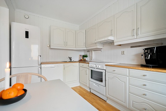 Klassisk kjøkken med profilerte fronter, lyse fargetoner og praktisk planløsning