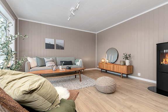 Stue med enstavs Pergo Trondheim i fargen Beige Oak, peisovn er Schiedel Sirius 1.