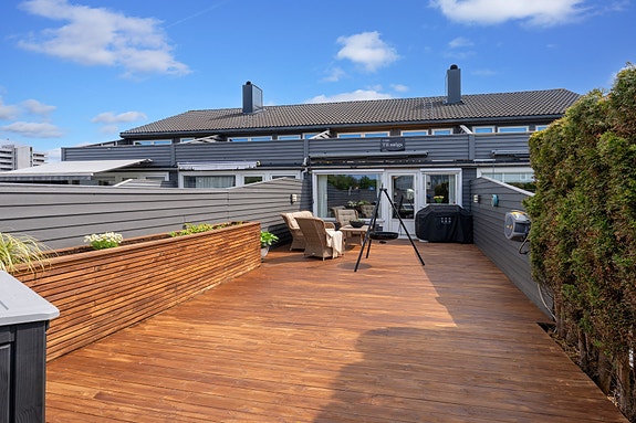 Flott utbygget rekkehus med vestvendt terrasse, 3 soverom, 2 stuer og parkeringsplass.