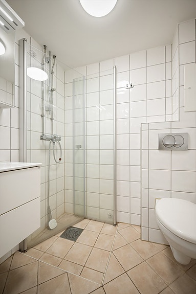 Et moderne og funksjonelt baderom med opplegg for vaskemaskin.