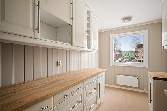 Kjøkken med god benkeplass og smarte løsninger for oppbevaring.