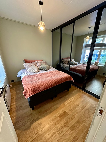 Soverom 1 med gode oppbevaringsmuligheter i tilpasset skyvedørsgarderobe
