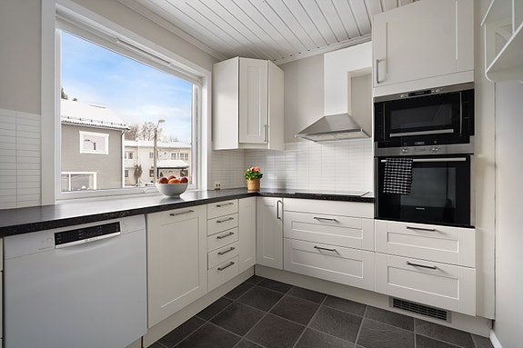 Kjøkkenet er utformet i vinkel og gir god plass for oppbevaring og arbeidsflater for matlaging