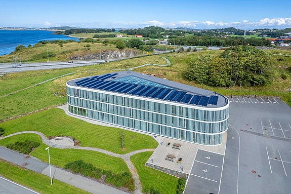 Moderne næringsbygg med solcellepaneler, vakker beliggenhet ved utsikt til sjø, gode parkeringsmuligheter og naturskjønne omgivelser. Ideelt for fremtidsrettede virksomheter.