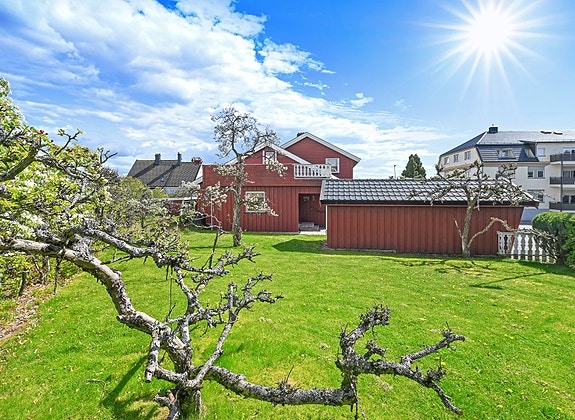 Eiendommen ligger i et sjarmerende og etablert nabolag, omgitt av frodig hage og grønne omgivelser, med kort vei til fjorden og flere populære badeplasser.