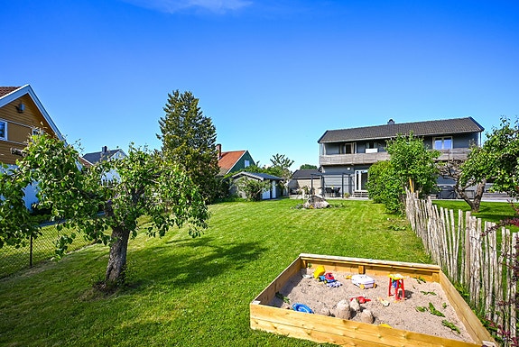 Den grønne hagen skaper luft rundt boligen og gode oppholdsarealer for hele familien.