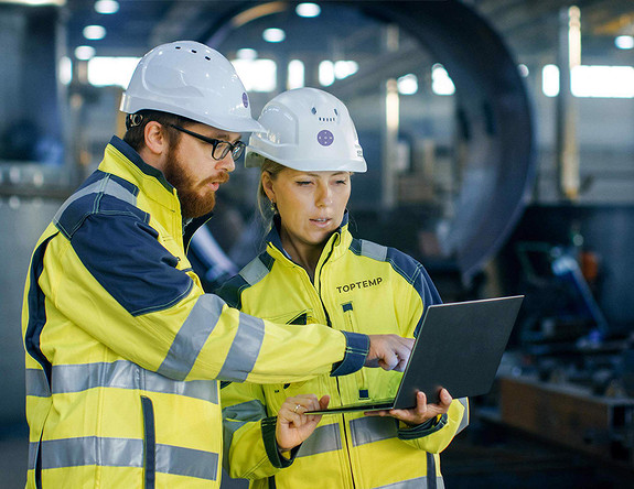 Toptemps ingeniører diskuterer løsninger på fabrikk.