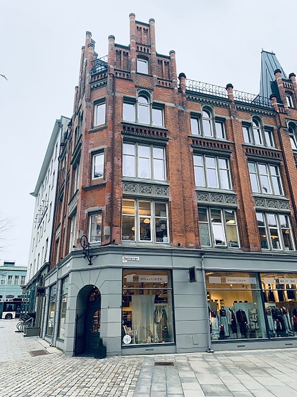 Inngangsparti i Vågsallmenningen 3 med butikk i 1.etg. og systue i 2.etg