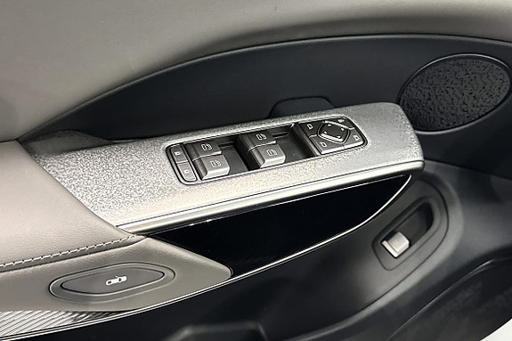 Detaljerte paneler med vinduskontroller og moderne materialvalg.