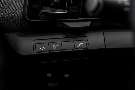 Knappkontroll for kjørefeltassistanse og antispinnsystem foran rattet.