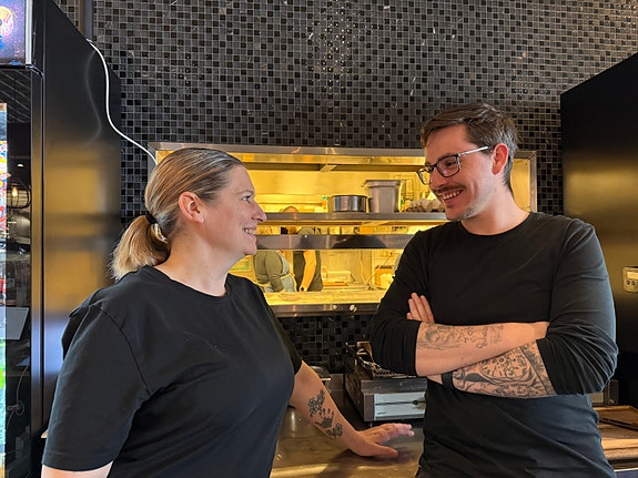 Arbeidsmiljøet beskrives som sosialt, inkluderende og preget av mye humor – særlig på kjøkkenet.
– Vi i serveringen bruker å spøke med at vi må gå og gi dem et glass vann når vitsene blir for tørre, humrer driftsleder Veronica.